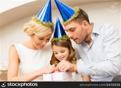 celebration, family, holidays and birthday concept - happy family with gift box