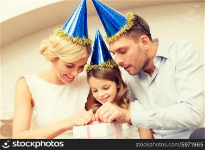 celebration, family, holidays and birthday concept - happy family with gift box
