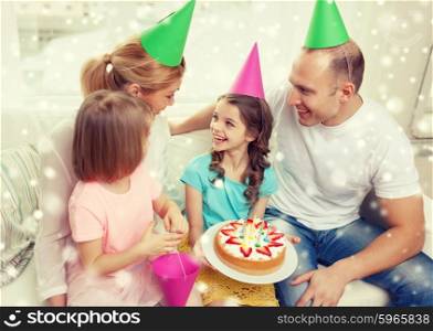 celebration, family, holidays and people concept - happy family with two kids in party hats at home