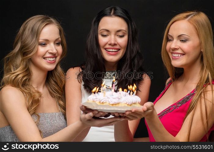 celebration, food, friends, bachelorette party and birthday concept - three smiling women holding cake with candles