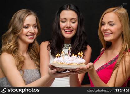 celebration, food, friends, bachelorette party and birthday concept - three smiling women holding cake with candles