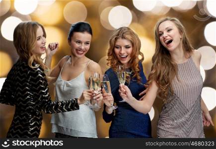 celebration, friends, bachelorette party and holidays concept - happy women clinking champagne glasses and dancing over lights background. happy women clinking champagne glasses over black