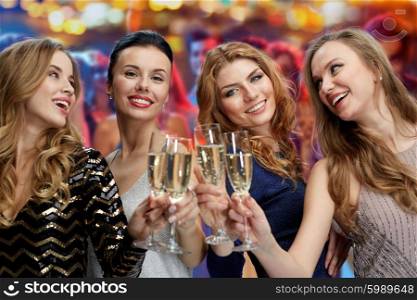 celebration, friends, bachelorette party and holidays concept - happy women clinking champagne glasses over nightclub lights background