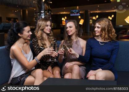 celebration, friends, bachelorette party and holidays concept - happy women clinking champagne glasses and celebrating at night club