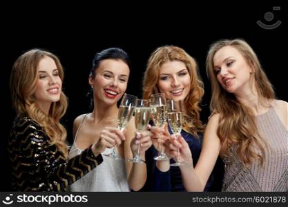 celebration, friends, bachelorette party and holidays concept - happy women clinking champagne glasses over black background