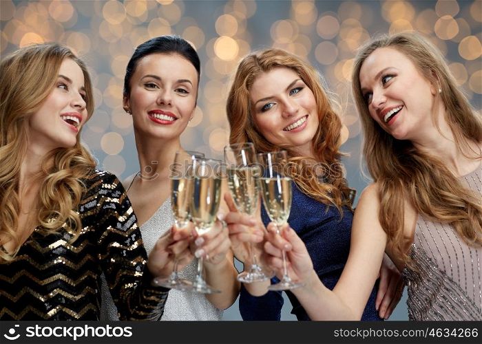 celebration, friends, bachelorette party and holidays concept - happy women clinking champagne glasses over lights background