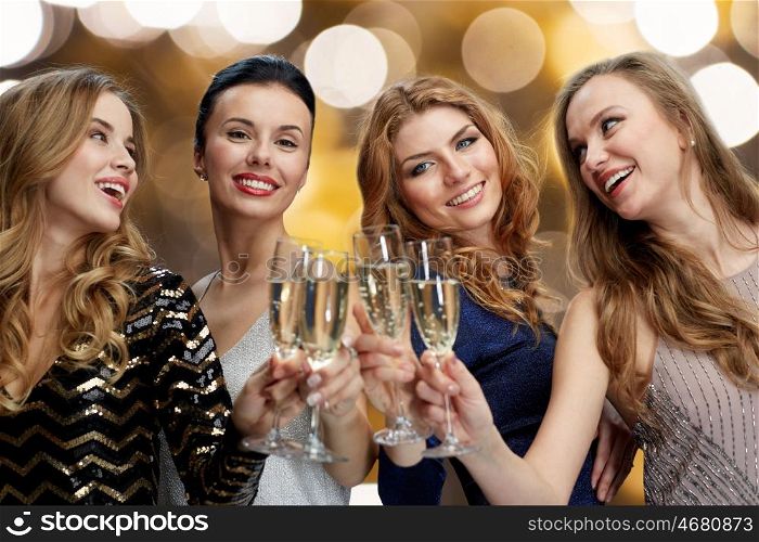 celebration, friends, bachelorette party and holidays concept - happy women clinking champagne glasses over lights background