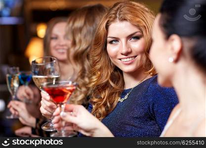 celebration, friends, bachelorette party and holidays concept - happy women drinking champagne and cocktails at night club