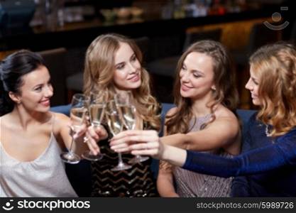 celebration, friends, bachelorette party and holidays concept - happy women with champagne glasses at night club