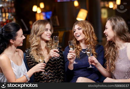 celebration, friends, bachelorette party and holidays concept - happy women with champagne glasses at night club