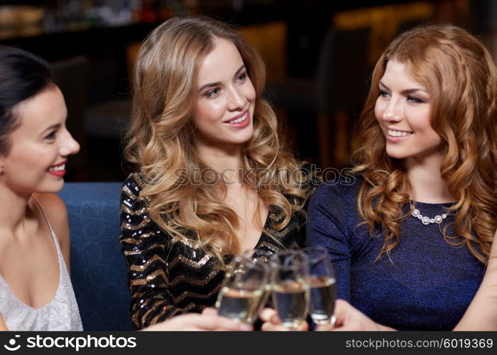 celebration, friends, bachelorette party and holidays concept - happy women with champagne glasses at night club