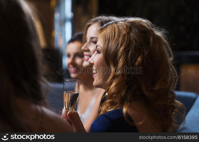 celebration, friends, bachelorette party and holidays concept - happy women with champagne glasses at night club