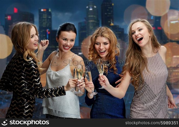 celebration, friends, bachelorette party, nightlife and holidays concept - happy women clinking champagne glasses and dancing over night city lights background
