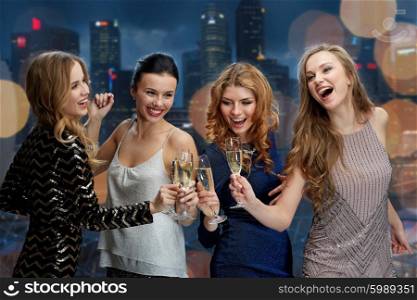 celebration, friends, bachelorette party, nightlife and holidays concept - happy women clinking champagne glasses and dancing over night city lights background
