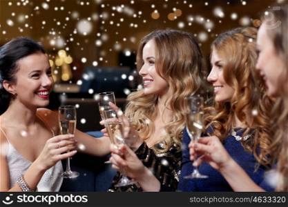 celebration, friends, new year, christmas and winter holidays concept - happy women with champagne glasses at bachelorette party at night club over snow. happy women with champagne glasses at night club