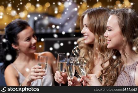 celebration, friends, new year, christmas and winter holidays concept - happy women with champagne glasses at bachelorette party at night club over snow