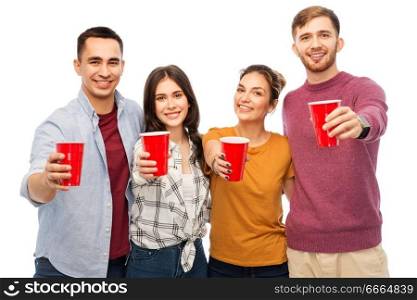 celebration, friendship and people concept - group of smiling friends with non alcoholic drinks in party cups over white background. group of smiling friends with drinks in party cups