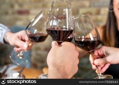 Celebration. Group of friends holding The Glasses Of Wine Making A Toast. High quality photo. Celebration. Group of friends holding The Glasses Of Wine Making A Toast.