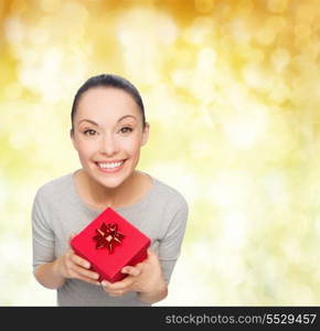 celebration, holidays and happiness concept - smiling asian woman with red gift box