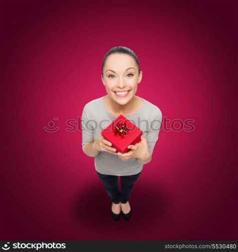 celebration, holidays and happiness concept - smiling asian woman with red gift box