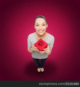 celebration, holidays and happiness concept - smiling asian woman with red gift box