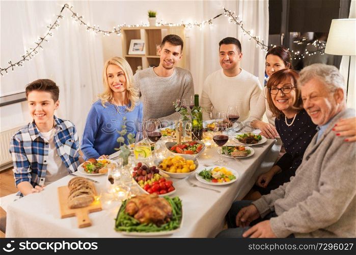 celebration, holidays and people concept - happy family having dinner party at home. happy family having dinner party at home