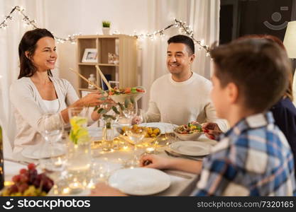 celebration, holidays and people concept - happy family having dinner party at home. happy family having dinner party at home