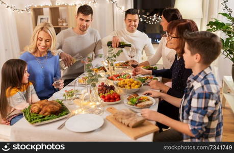 celebration, holidays and people concept - happy family having dinner party at home. happy family having dinner party at home