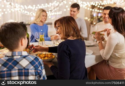 celebration, holidays and people concept - happy family having dinner party at home. happy family having dinner party at home