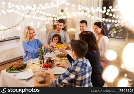 celebration, holidays and people concept - happy family having dinner party at home. happy family having dinner party at home