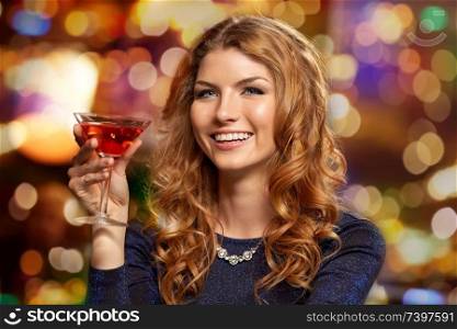 celebration, party and holidays concept - woman with glass of non-alcoholic cocktail at night club. woman with glass of cocktail at night club
