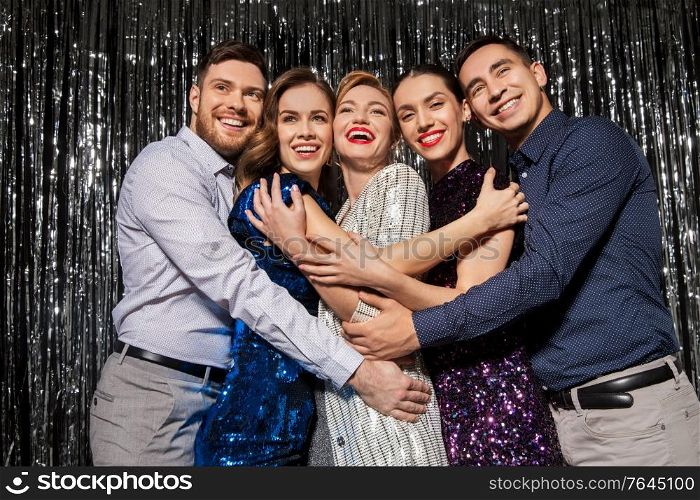 celebration, people and holiday style concept - happy friends in party clothes over black background. happy friends in party clothes