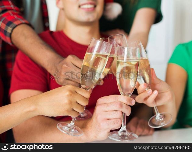celebration, people and holidays concept - close up of happy friends clinking glasses of champagne at party. friends clinking glasses of champagne at party