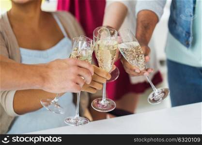 celebration, people and holidays concept - close up of happy friends clinking glasses of champagne at party. friends clinking glasses of champagne at party