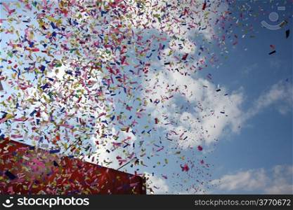 Celebration with Colorful confetti wiith blue sky in the background