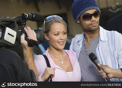 Celebrity couple being interviewed by the media