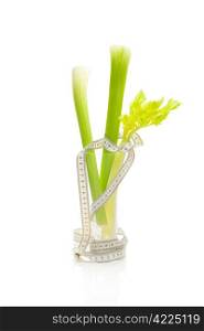 celery in a tall glass and measure tape isolated on white