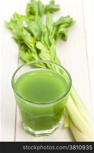 Celery juice on white wood wood