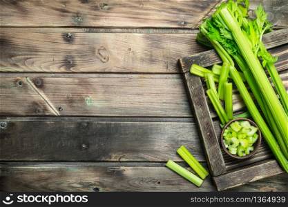 Celery on a wooden tray. On wooden background. Celery on a wooden tray.
