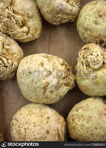 celery roots in market place as background