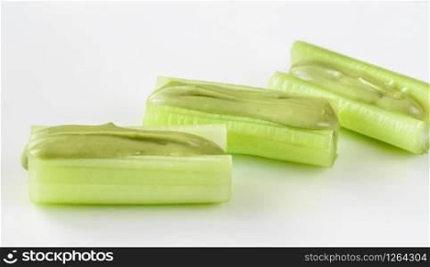 Celery stalks with pistachio butter isolated