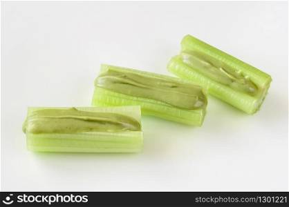 Celery stalks with pistachio butter isolated