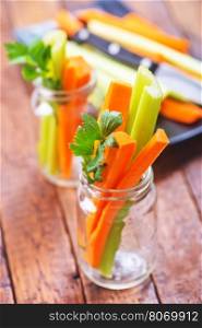 celery with carrot on plate and on a table