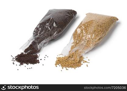 Cellophane bags with yellow and brown mustard seed isolated on white background