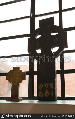 Celtic crosses sitting on windowsill.