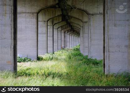 Cement arches under the bridge on the highway, Italy
