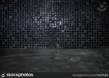 Cement floor with black stone and shiny mosaic wall background