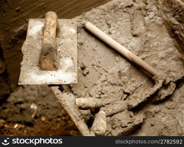 cement mortar dirty grunge tools like trowel spatula and hoe