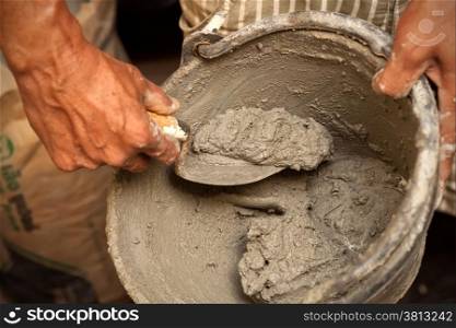 Cement mortar mixed with trowel in bucket
