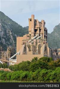 Cement plant with limestone mountain background